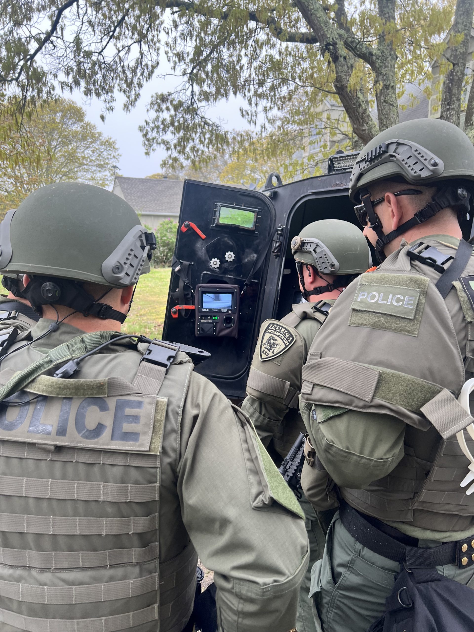 Tactical team using tactical robot for surveillance
